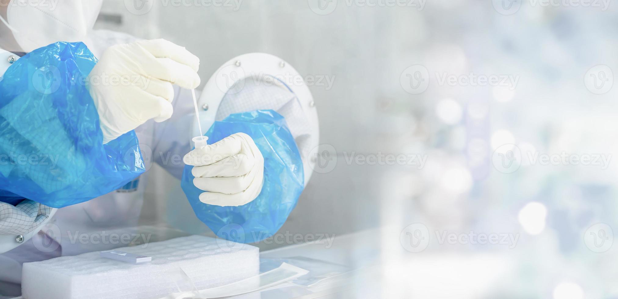 Close up to the rubber gloves on the asian medical staff is processing coronavirus or covid-19 test in the negative room pressure. photo