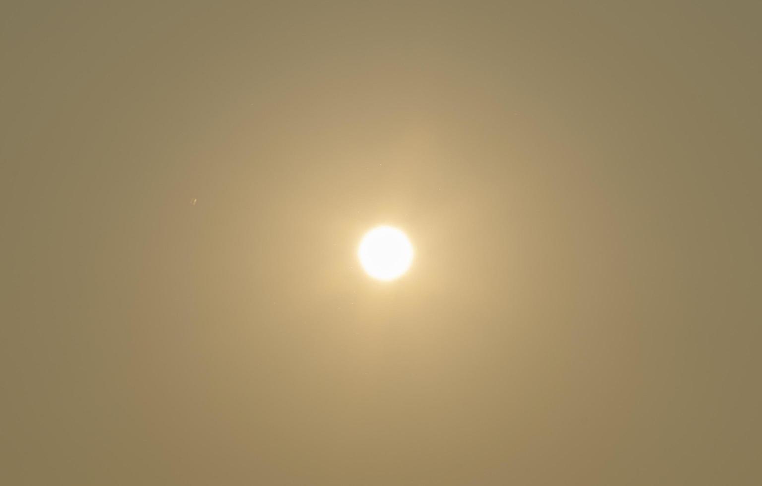 The sun on the yellow sky photo