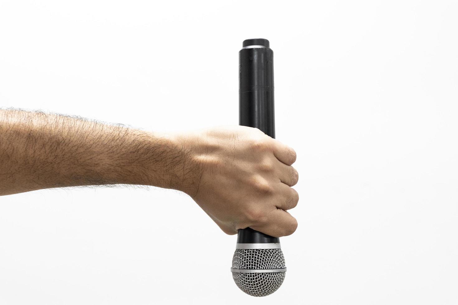Hand holding microphone on white background photo
