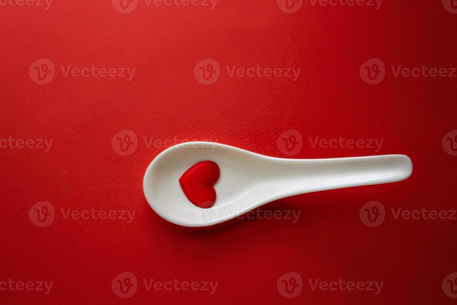 Red Heart shape in white spoon , Heart health and food , romantic dinner photo