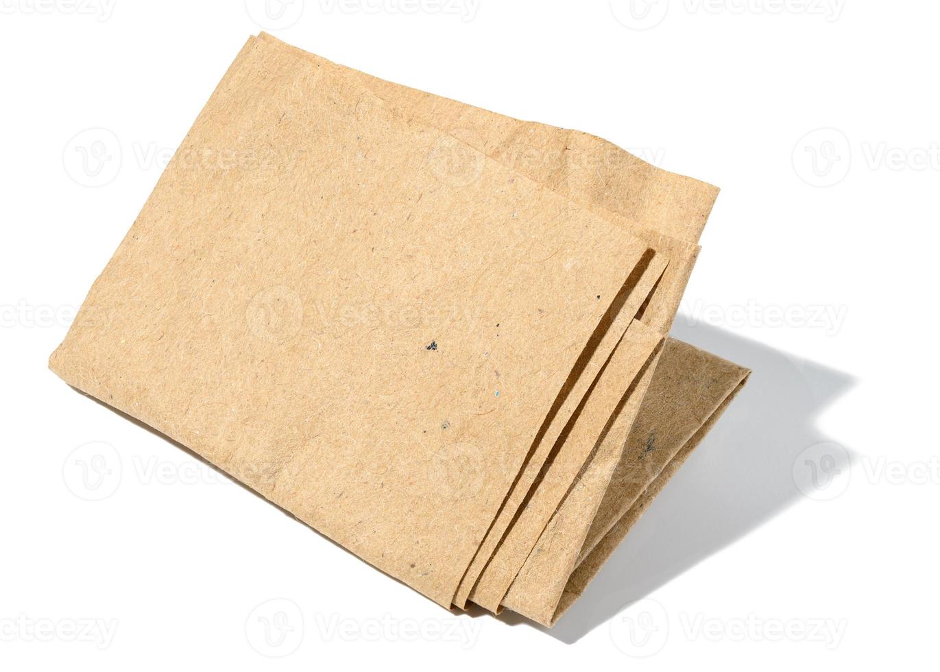 Piece of crumpled brown paper isolated on white background photo