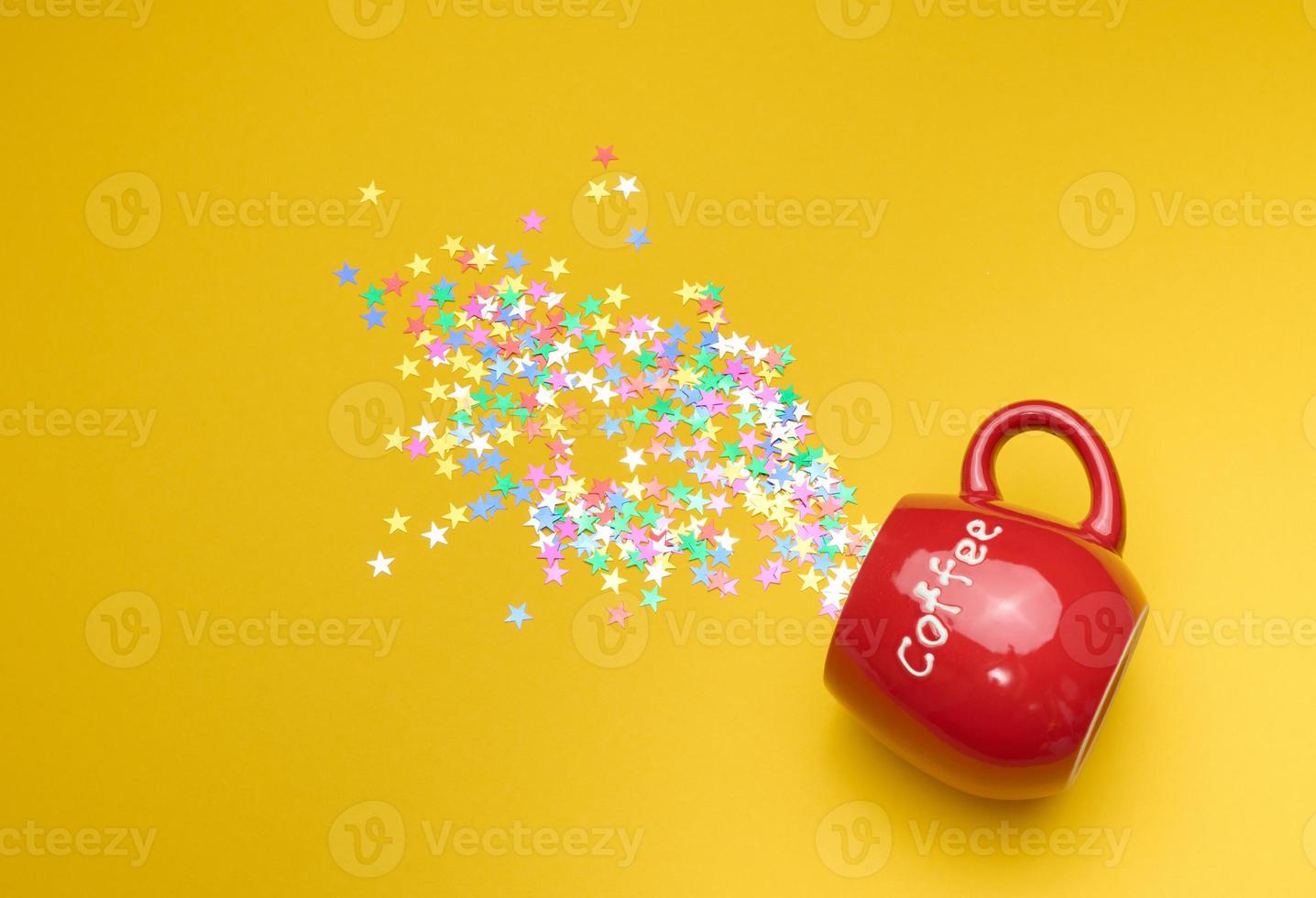 Shiny multicolored star confetti scattered on a yellow background, festive backdrop for birthday photo