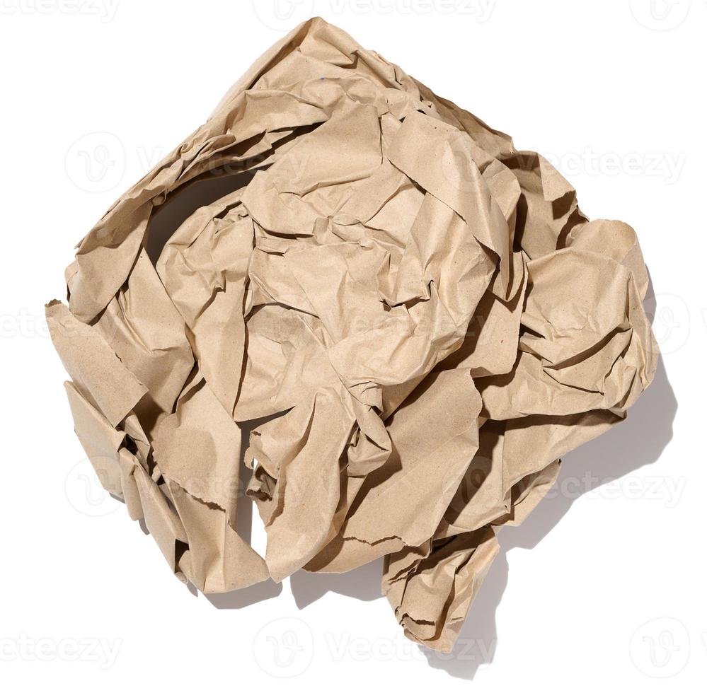 Crumpled brown sheet of paper isolated on white background photo