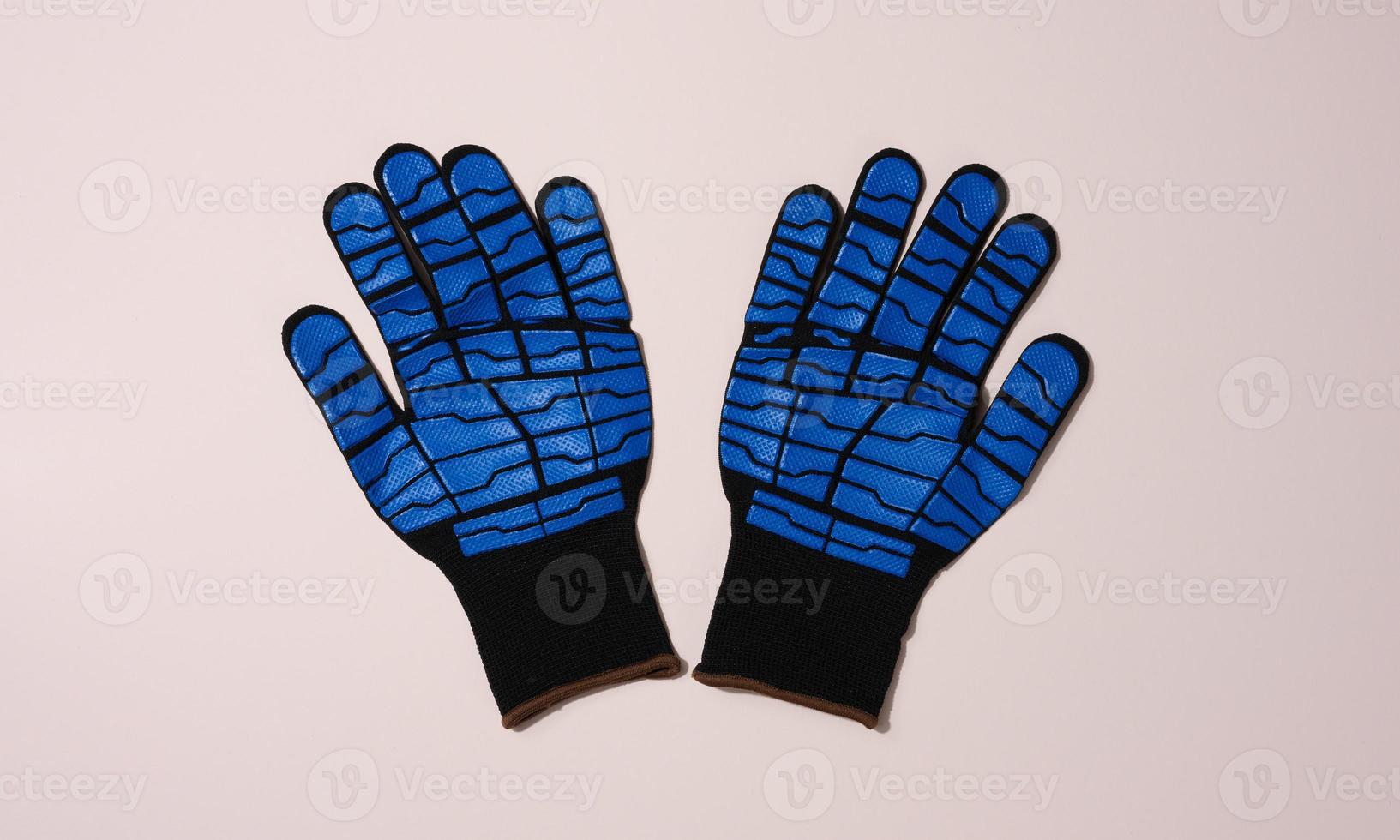 Knitted gloves with embossed latex coating to protect against mechanical damage and cuts. photo