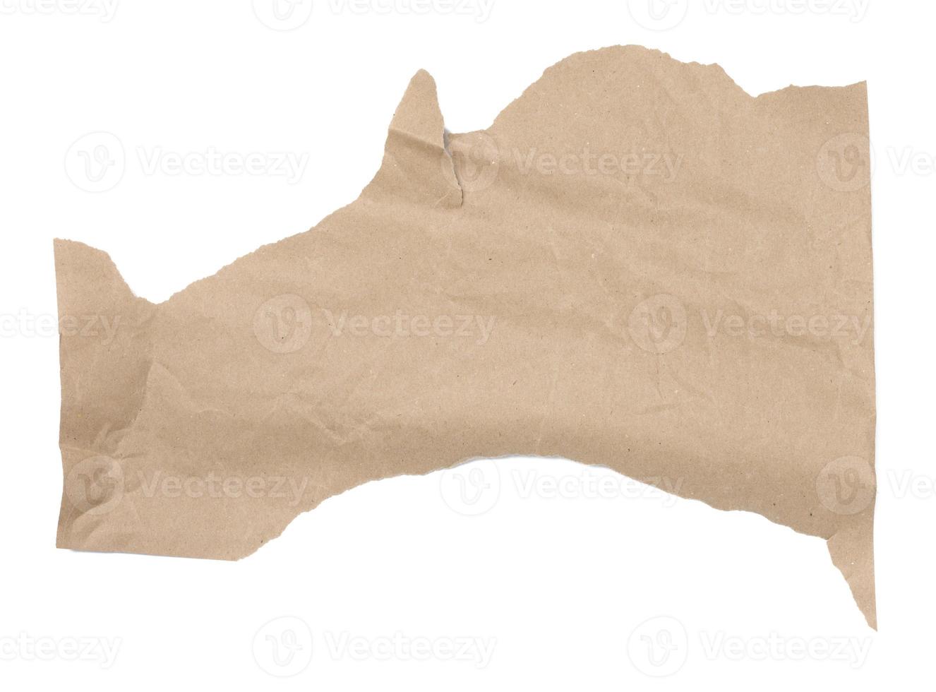 Piece of crumpled brown paper isolated on white background, element for designer, torn edges photo