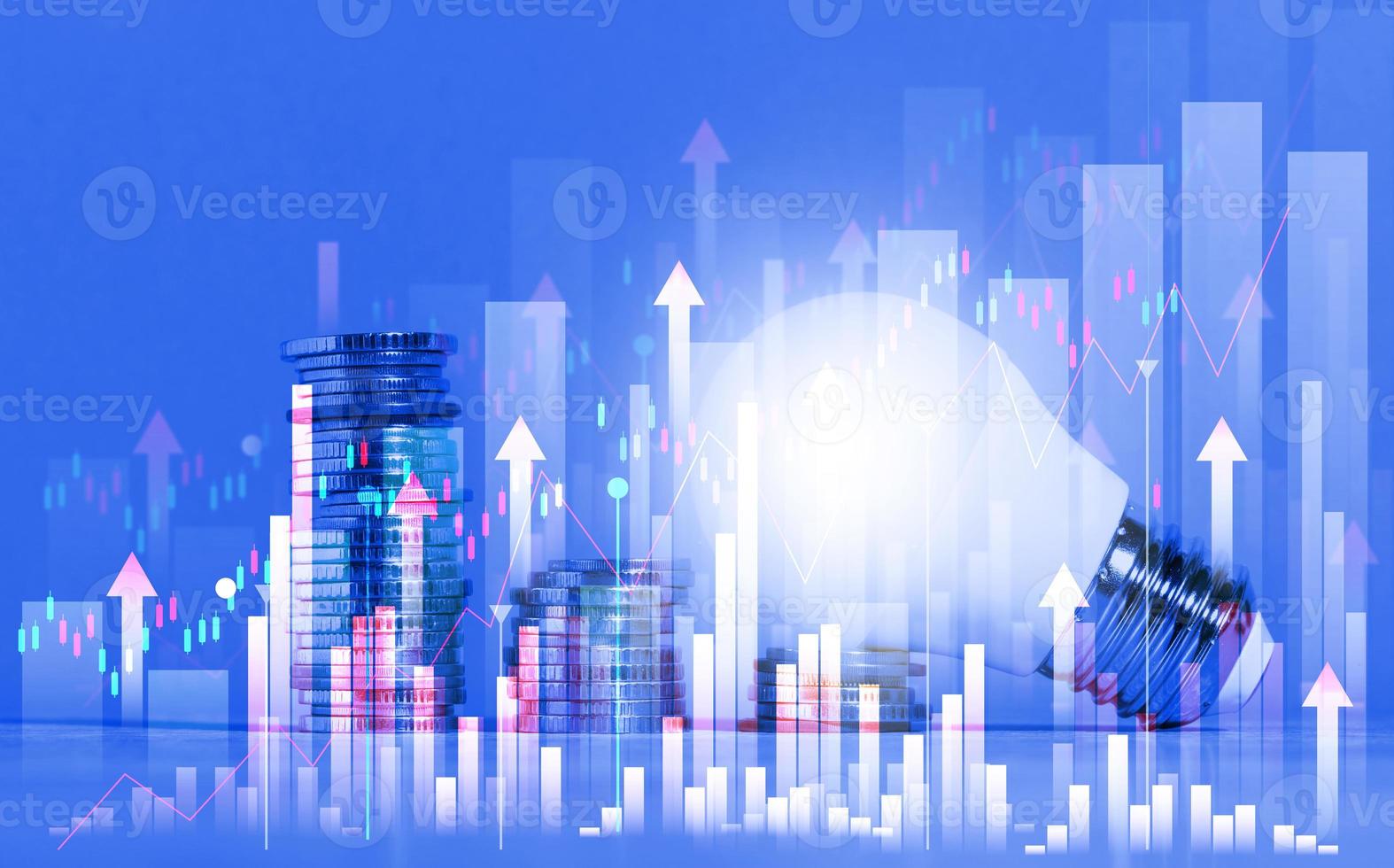 A stack of coins and a light bulb on a blue background, a graph of the growth in energy prices, the introduction of business innovation and high income photo