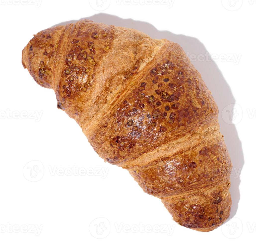 Baked croissant on a white isolated background, top view photo