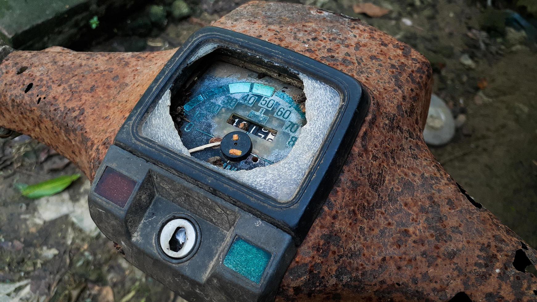 old motorbike speedometer that is broken and rusty photo