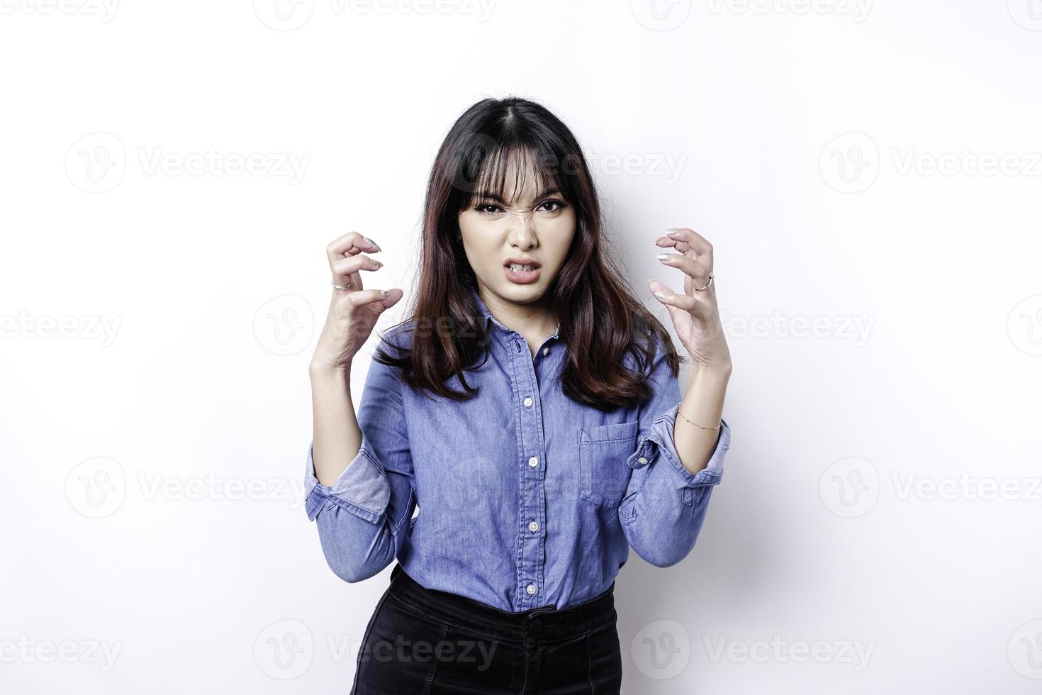 A portrait of an Asian woman wearing a blue shirt isolated by white background looks depressed photo