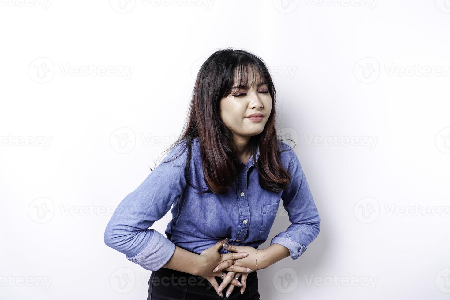 Photo of young unwell sick ill woman hold hand on stomach suffers pain isolated on white background