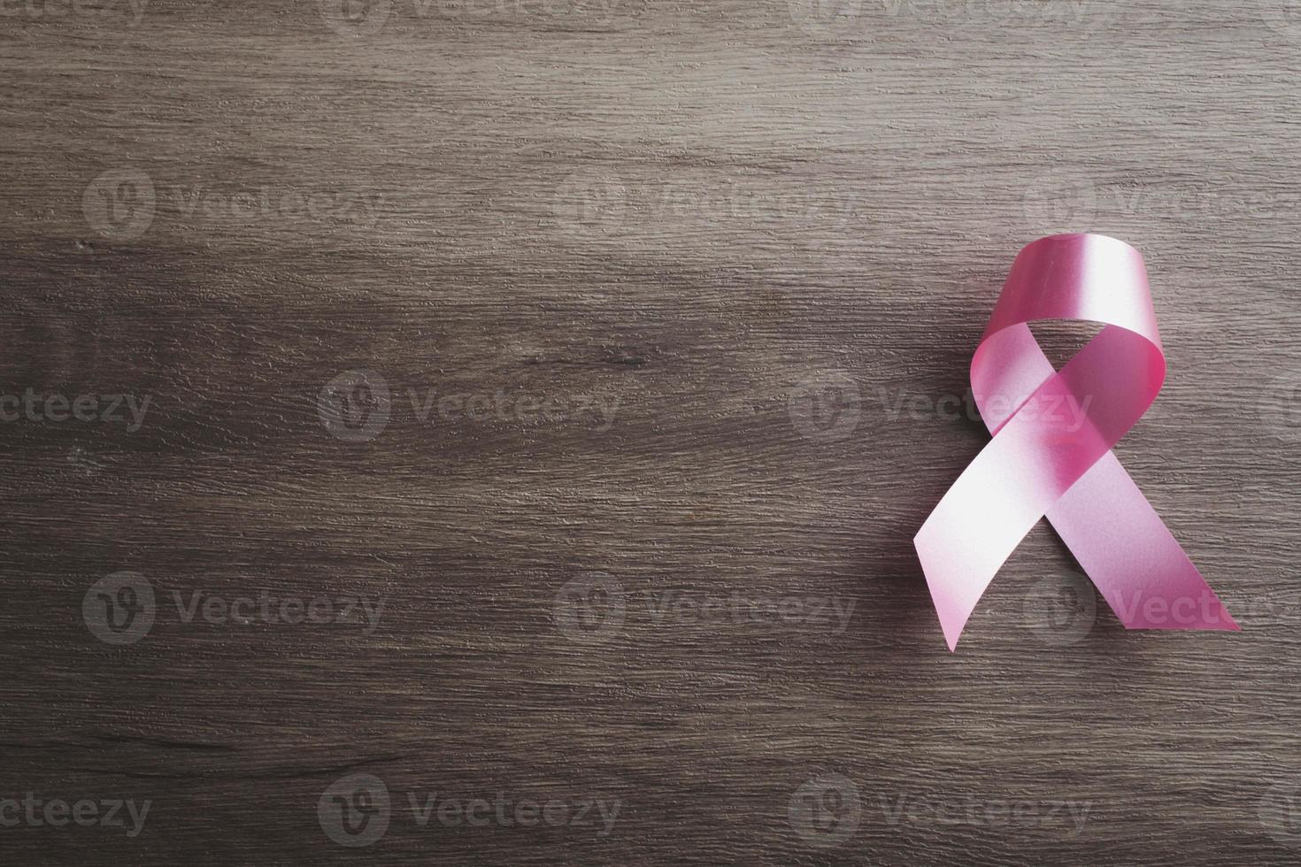 Pink ribbon on gray background.Symbol of breast cancer. photo