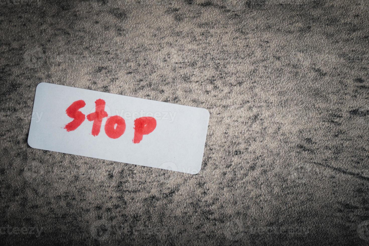 a piece of paper after writing the word 'STOP'. photo