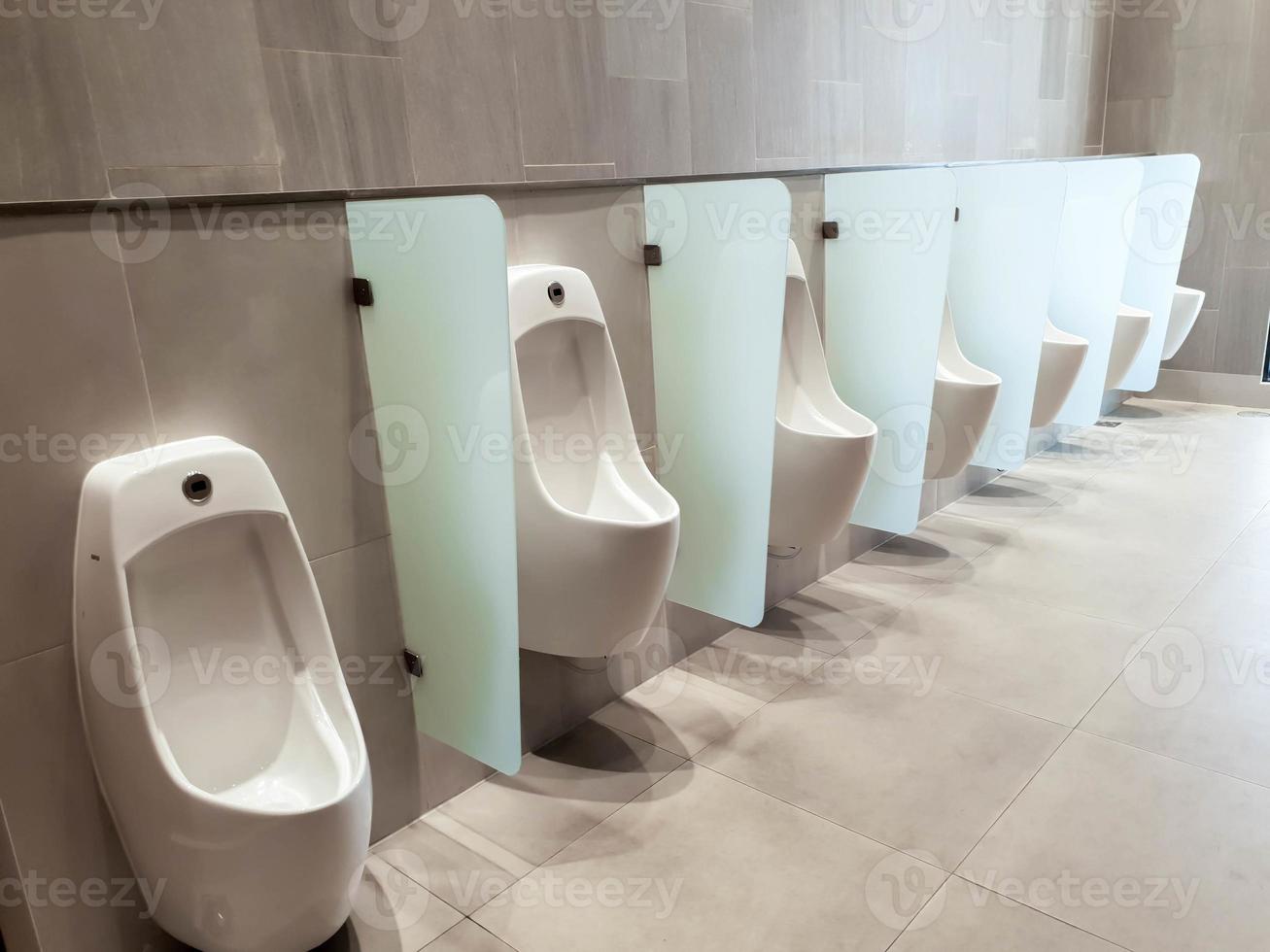 Perspective view of men urinal with automatic cleaning system in public toilet of shopping mall. photo