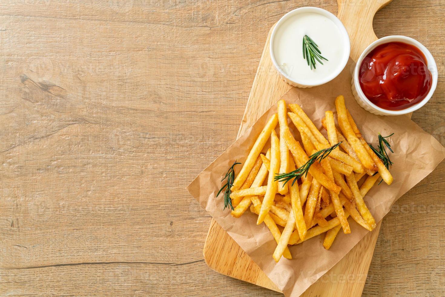 French fries with sour cream and ketchup photo