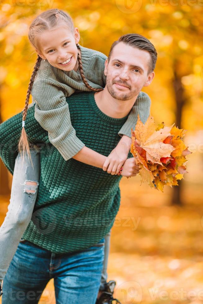 Family of dad and kid on beautiful autumn day in the park photo