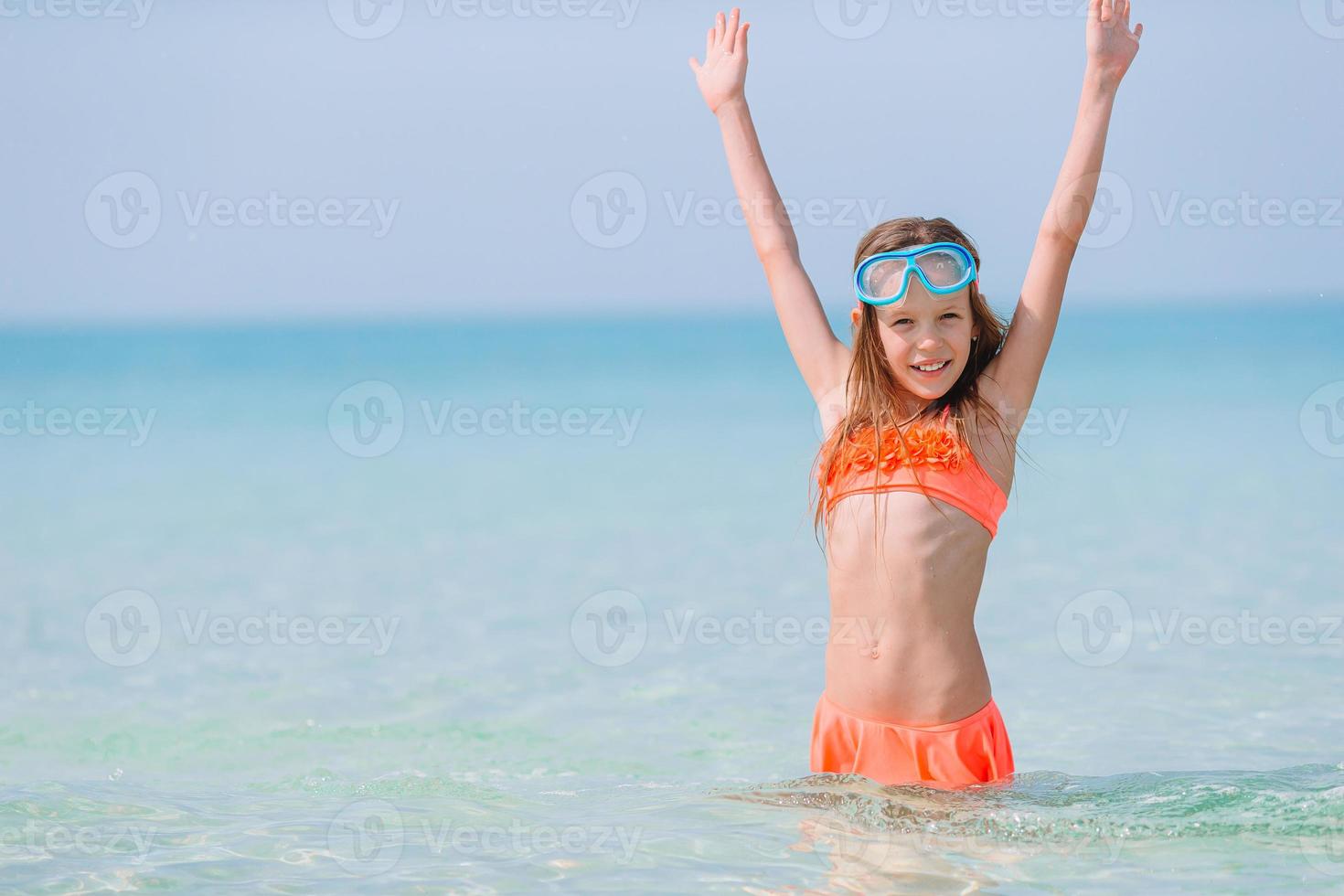 Cute little girl at beach during caribbean vacation photo