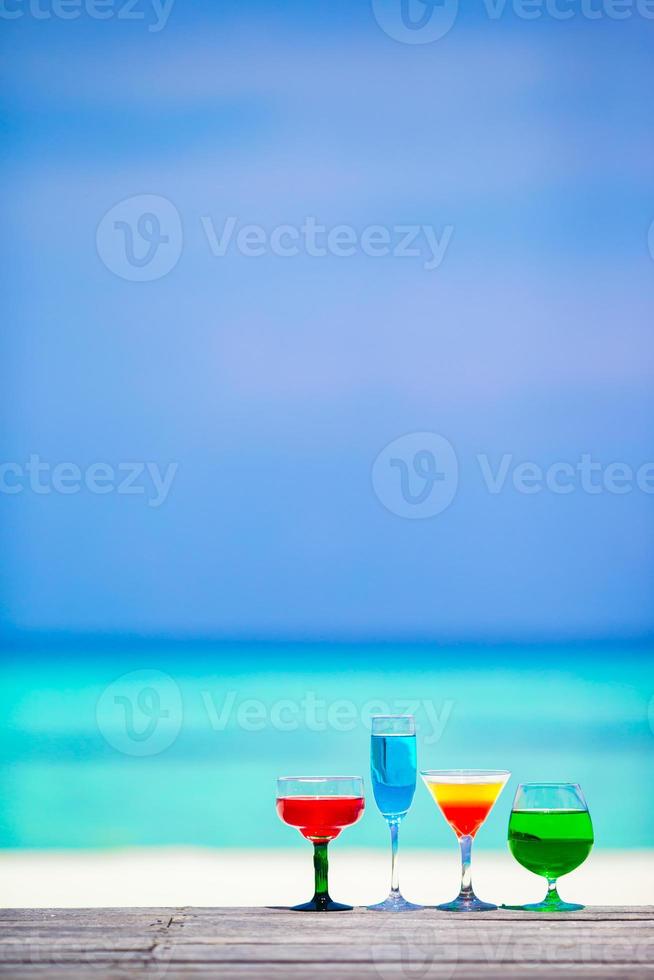 Colorful exotic tasty cocktails in outdoor cafe background turquoise sea at exotic resort photo