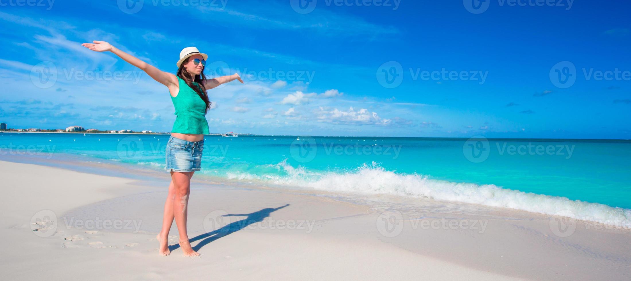 Young beautiful woman on beach during tropical vacation photo