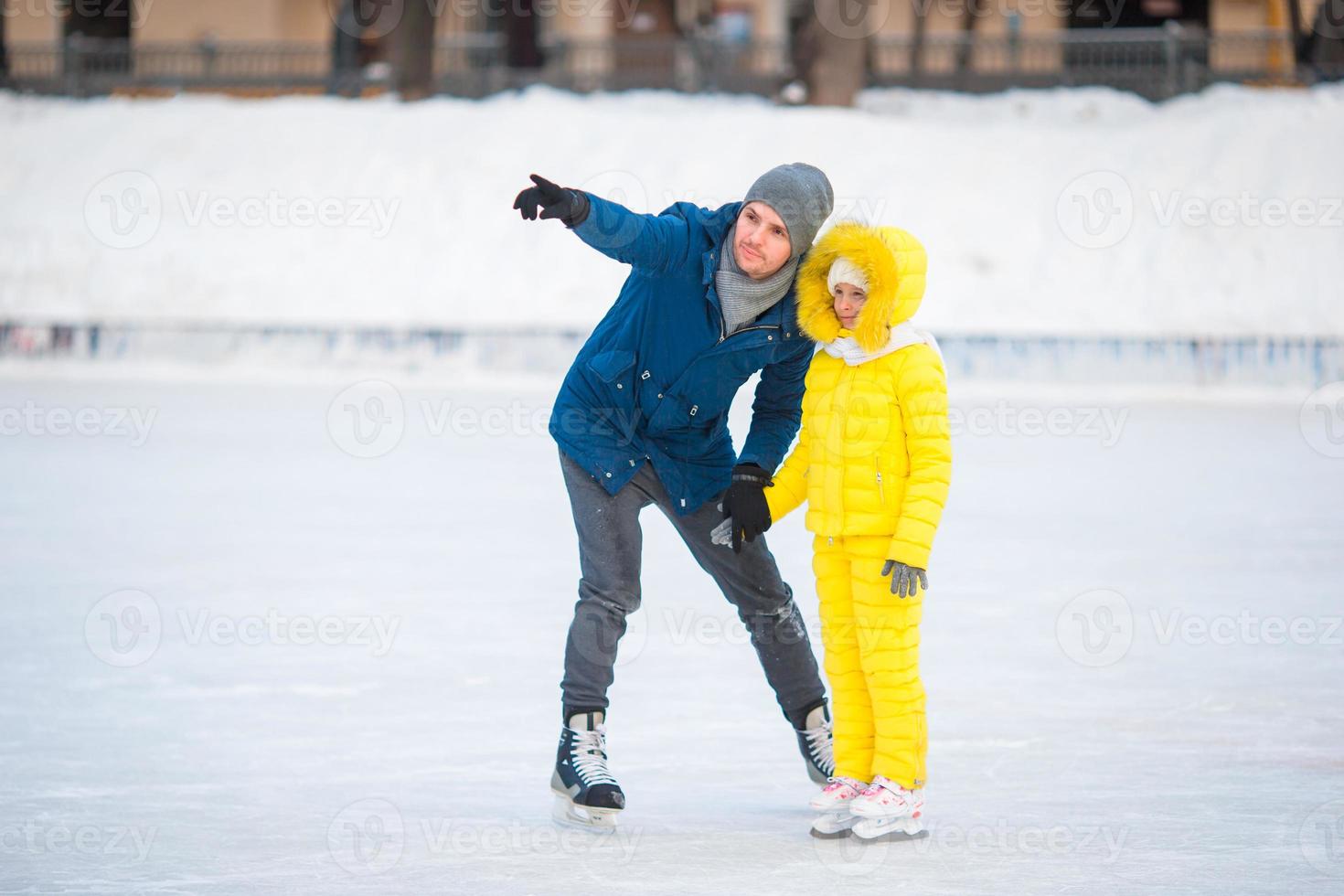 Family have fun on skating rink outdoors photo