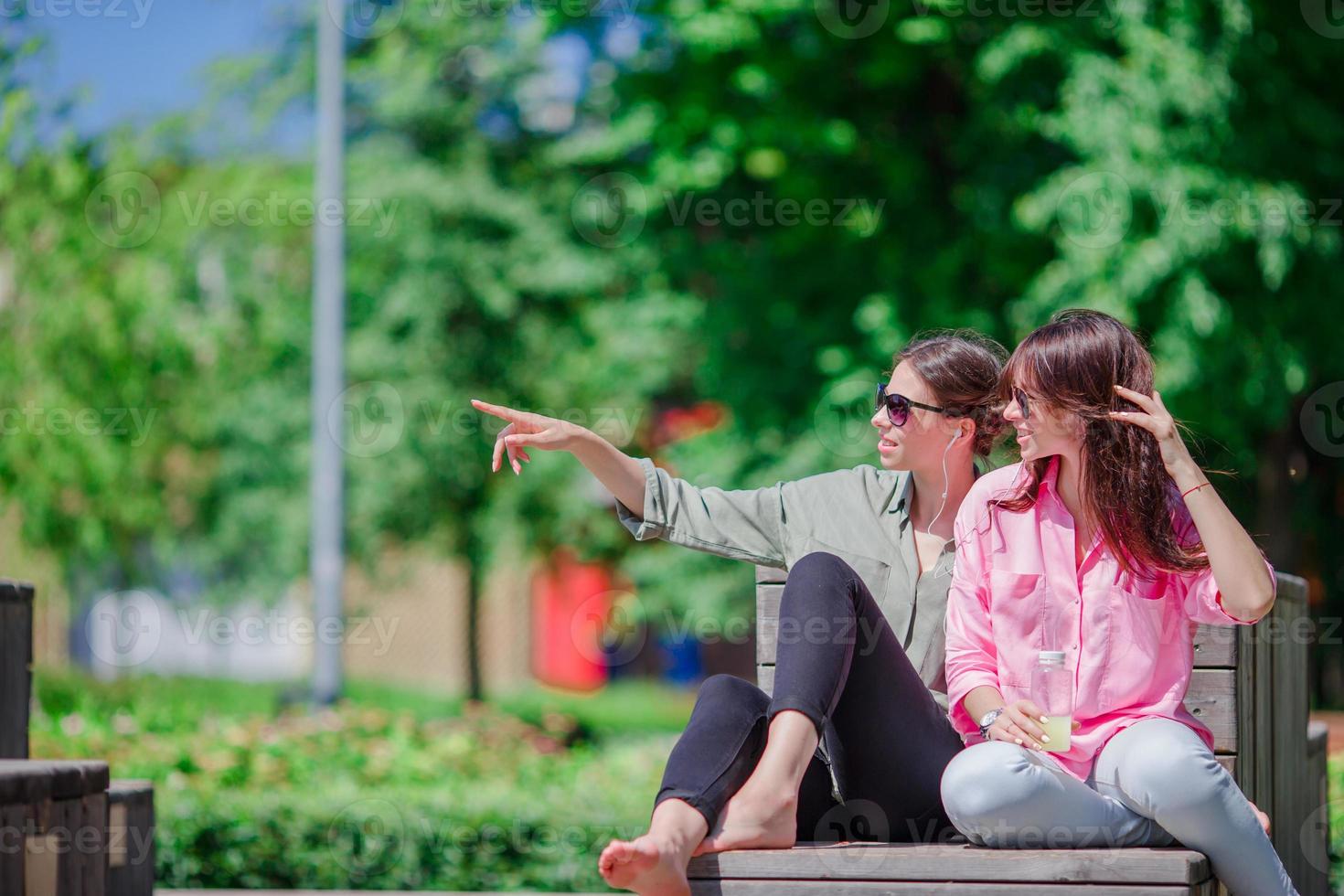 Happy young urban girls in european city. Caucasian beautiful women having fun together outdoors photo