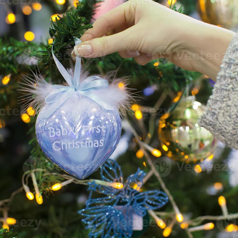 Colorful decorations and balls First Christmas on the branches of fir photo