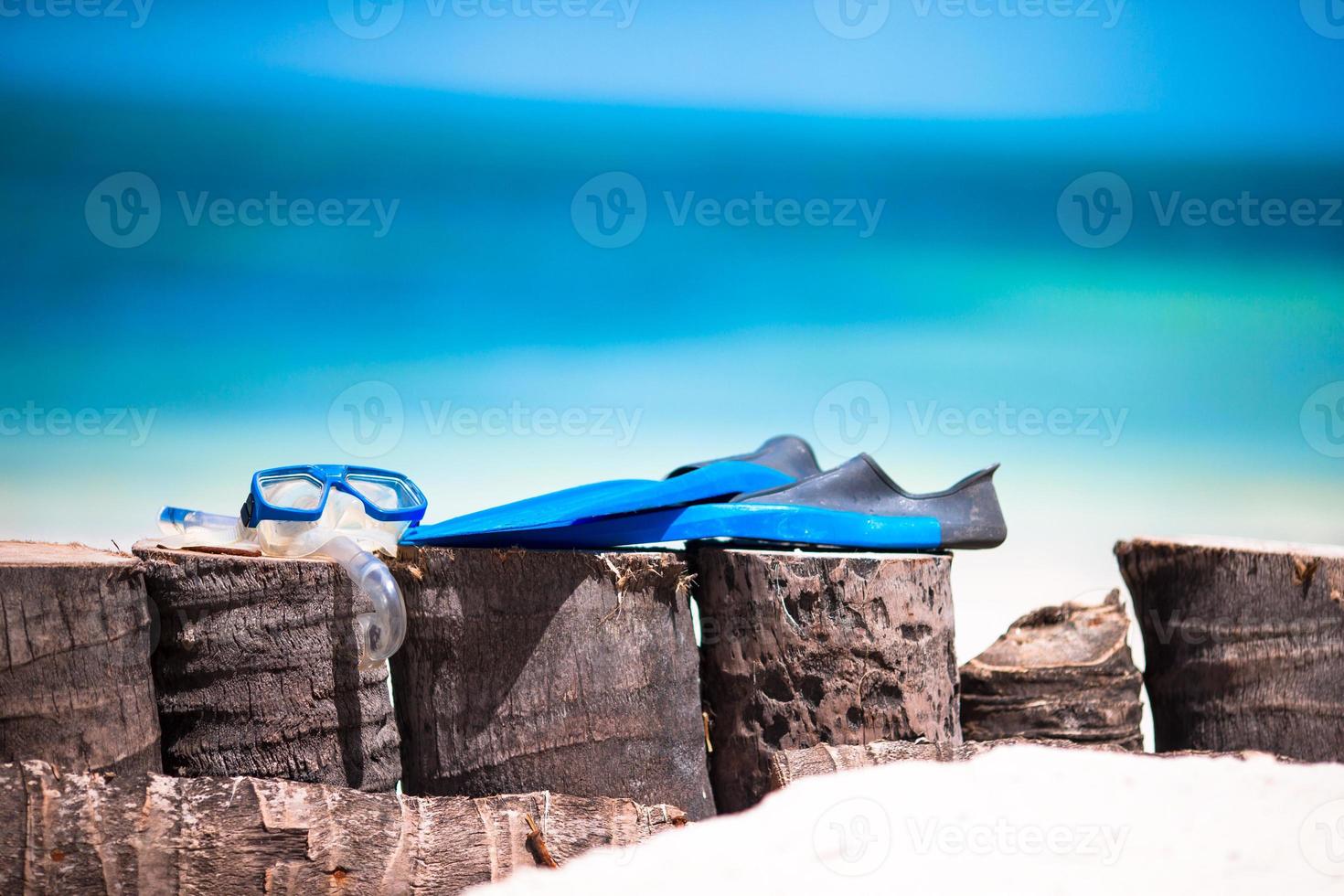 Snorkling equipment mask, snorkel and fins on white beach photo