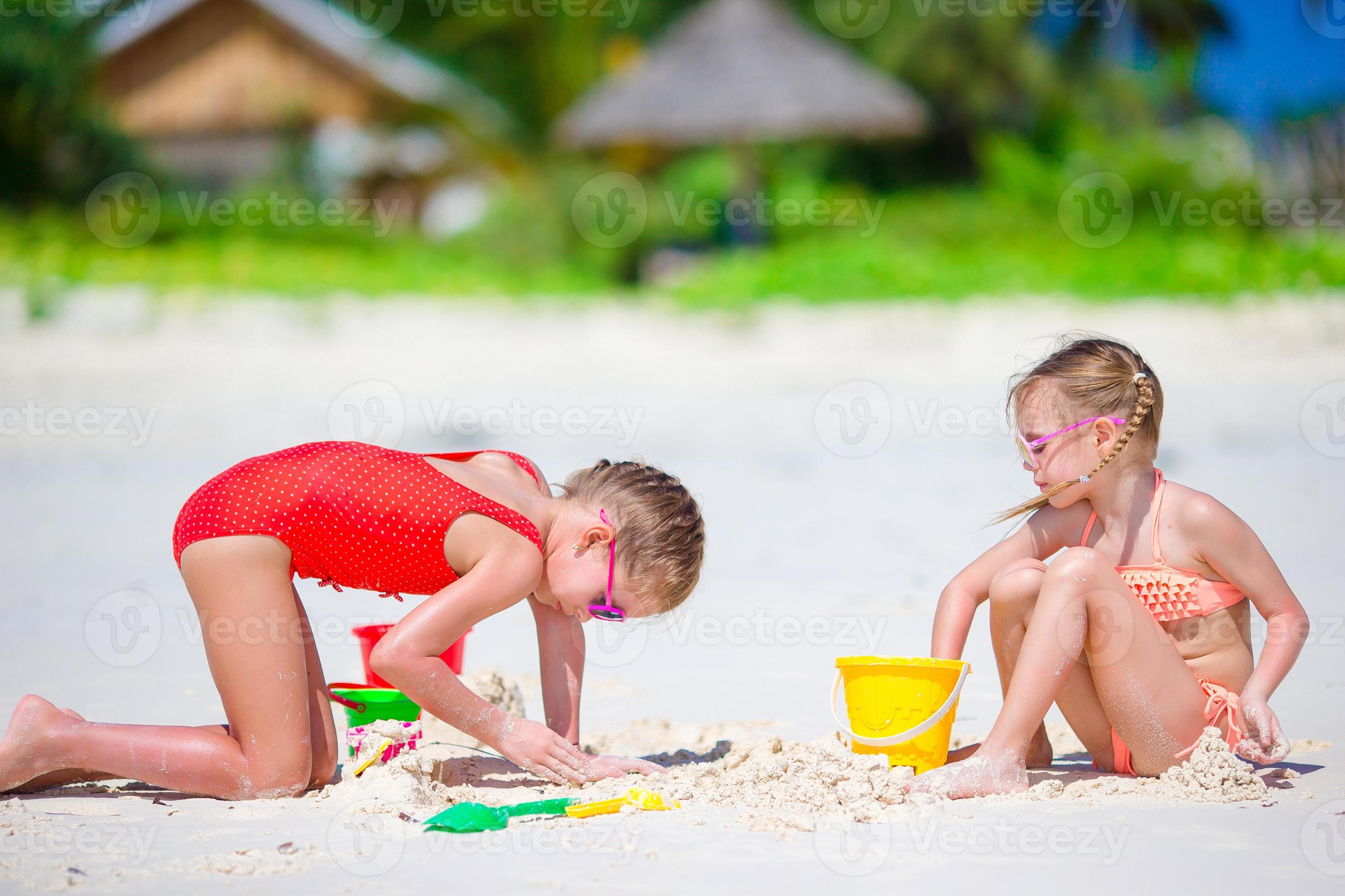 Adorable little girls during summer vacation. Kids playing with beach toys  on the white beach 17750869 Stock Photo at Vecteezy