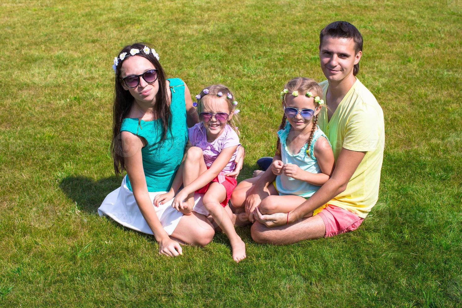 Happy family with two children outdoors on summer day photo