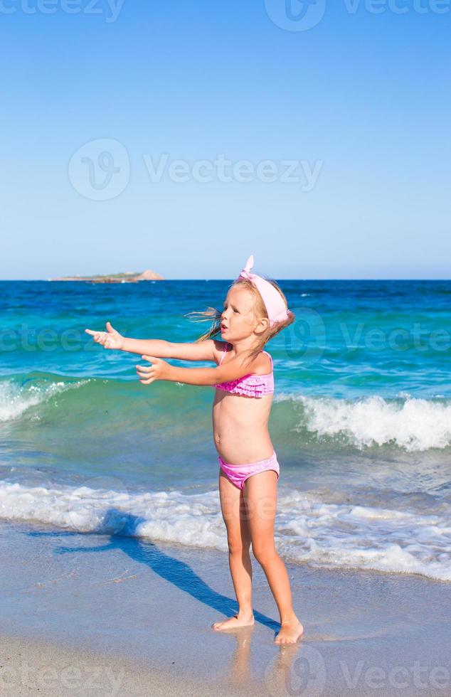 niña feliz durante las vacaciones en la playa tropical foto