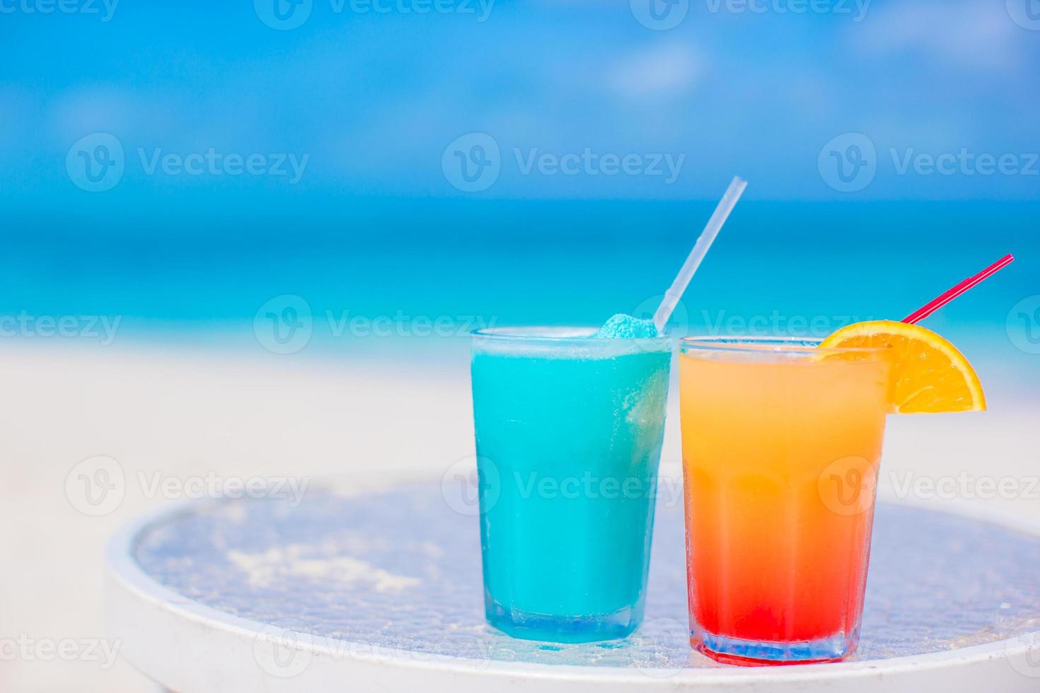 Two tasty cocktails on tropical white beach photo