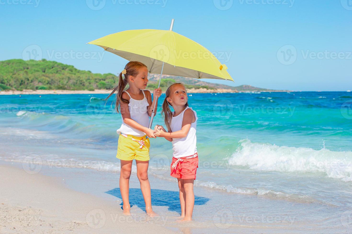 Kids have a lot of fun at tropical beach playing together photo