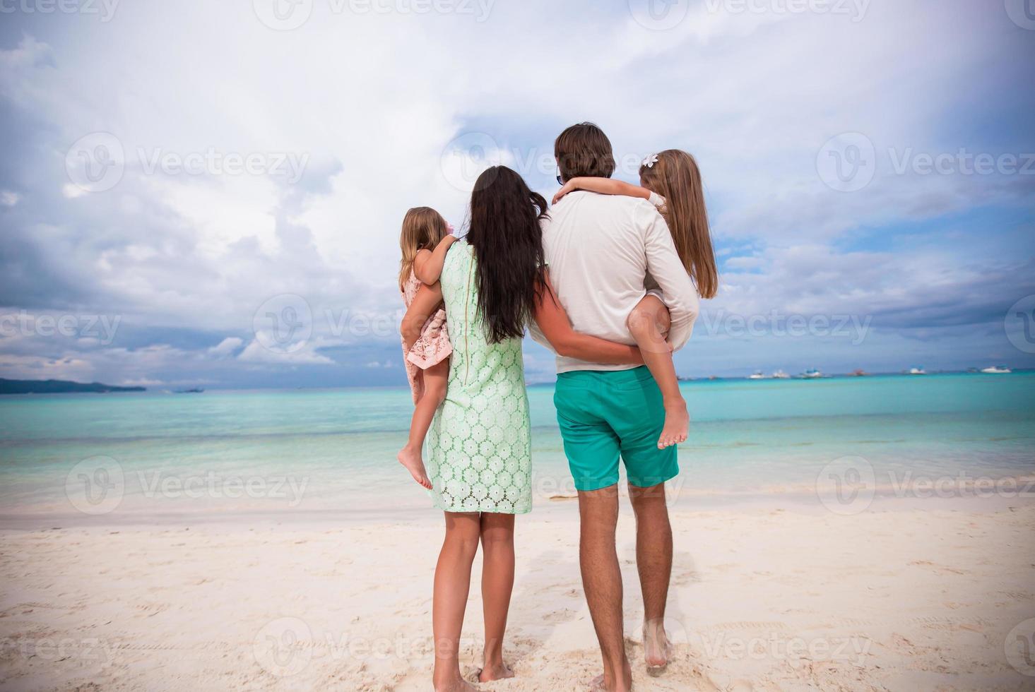 Happy family of four during summer vacation photo