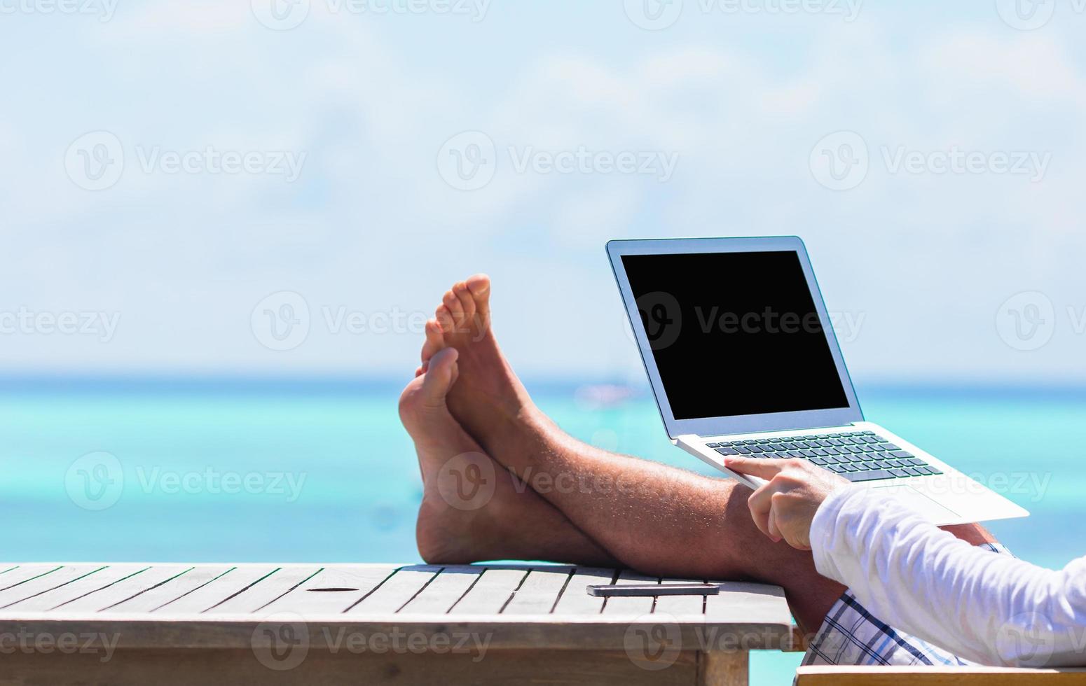 Closeup of computer on table background the sea photo