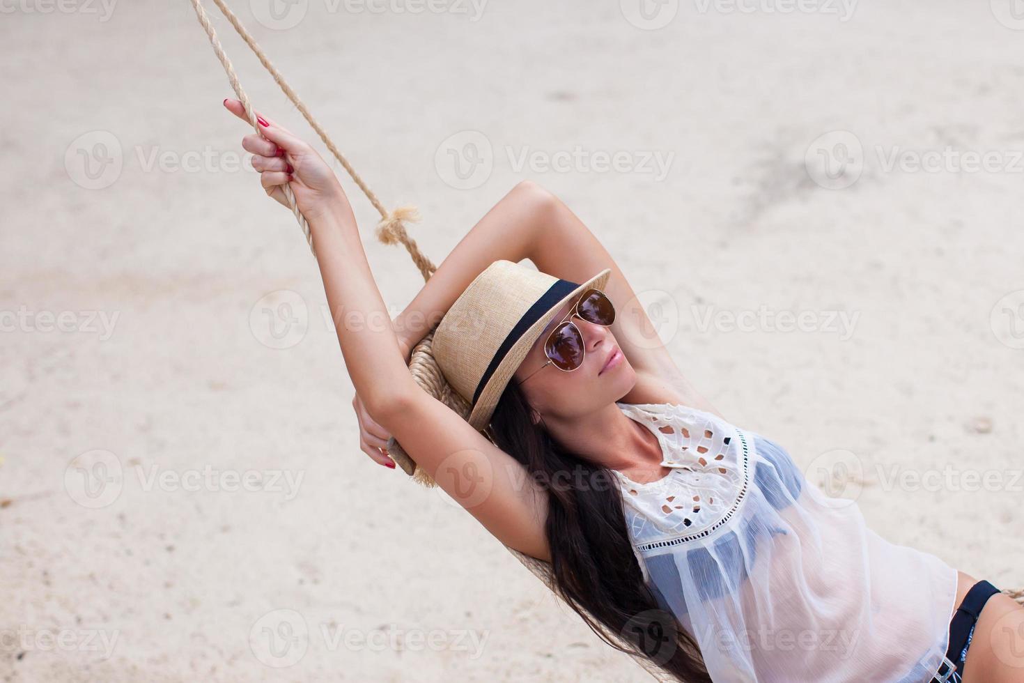 Young woman enjoying a sunny day in the hammock photo