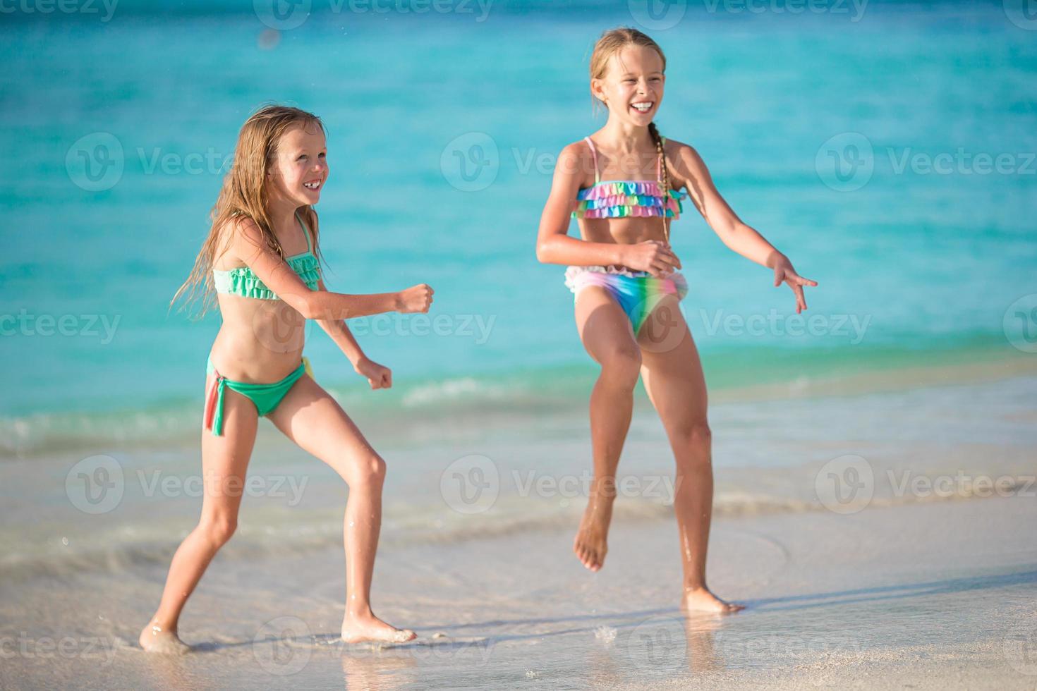 Kids have a lot of fun at tropical beach playing together photo