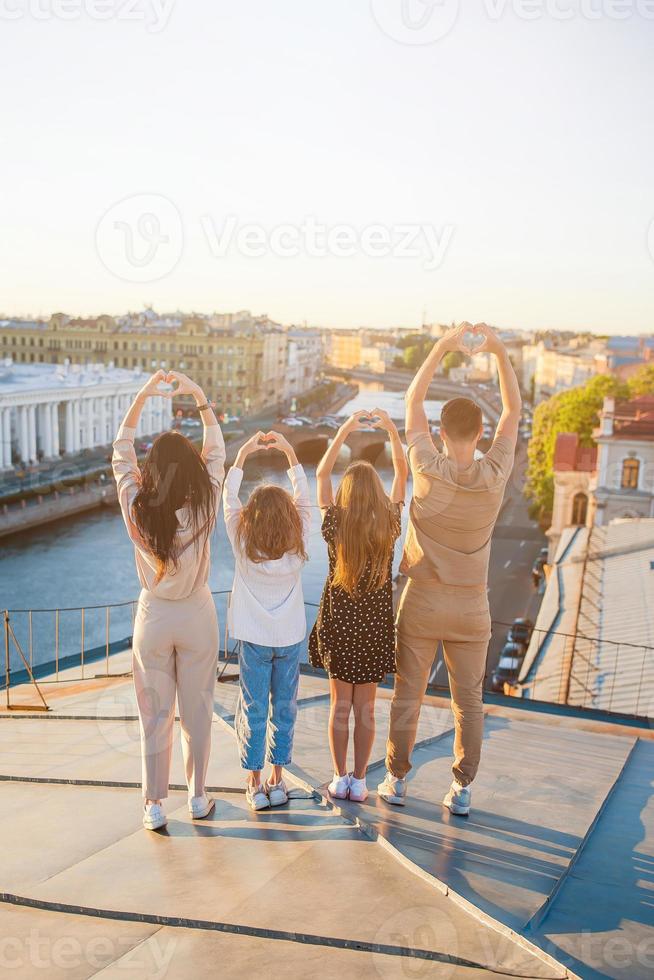 Family on rooftop enjoying with view of beautiful sunset in Sankt Petersburg in Russia photo