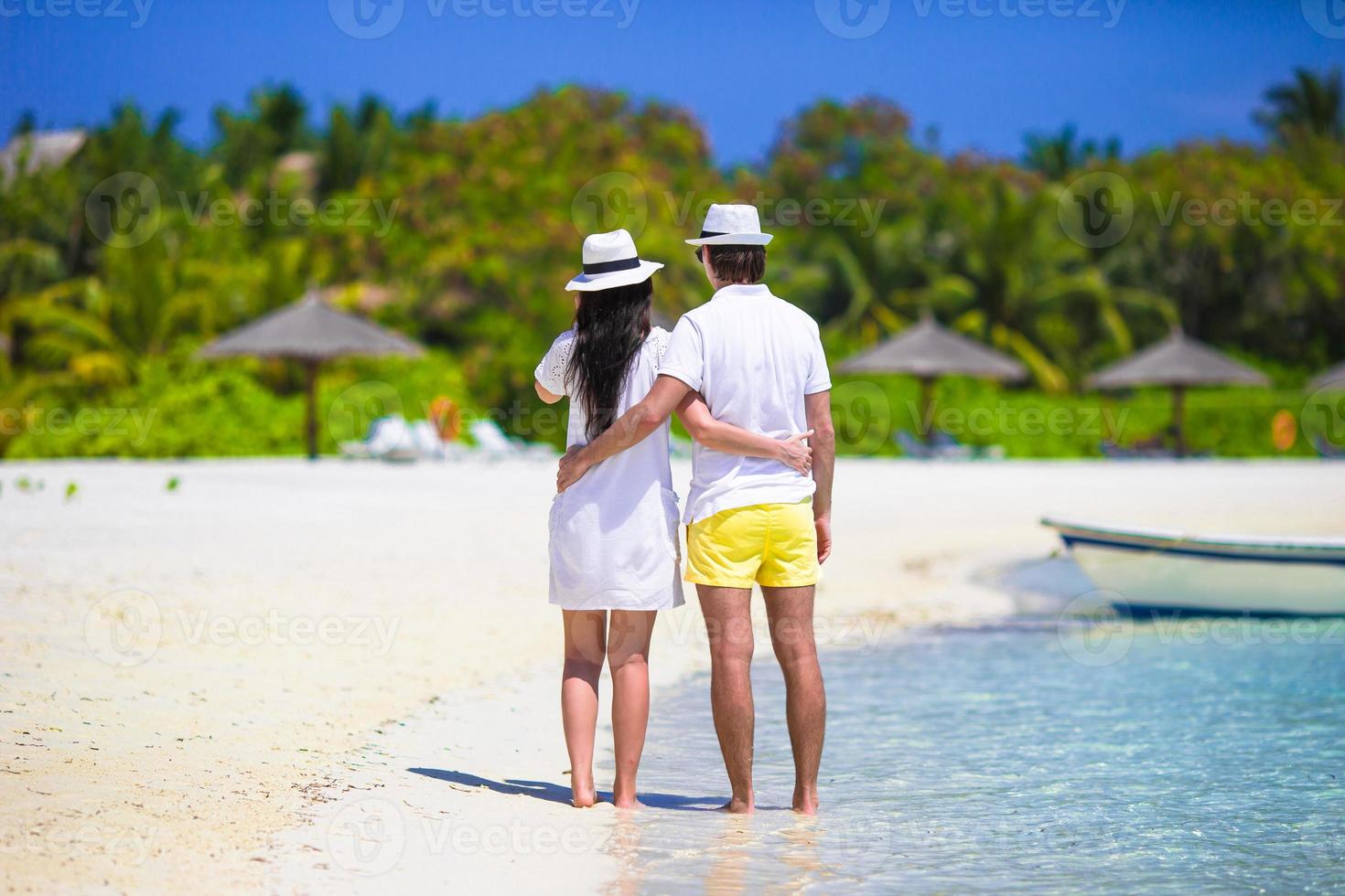 Young couple on white beach at summer vacation photo