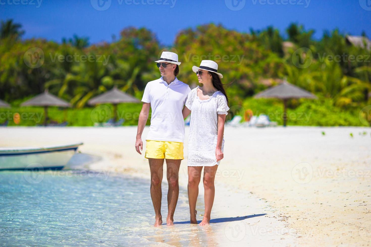 Young happy couple on white beach at summer vacation photo