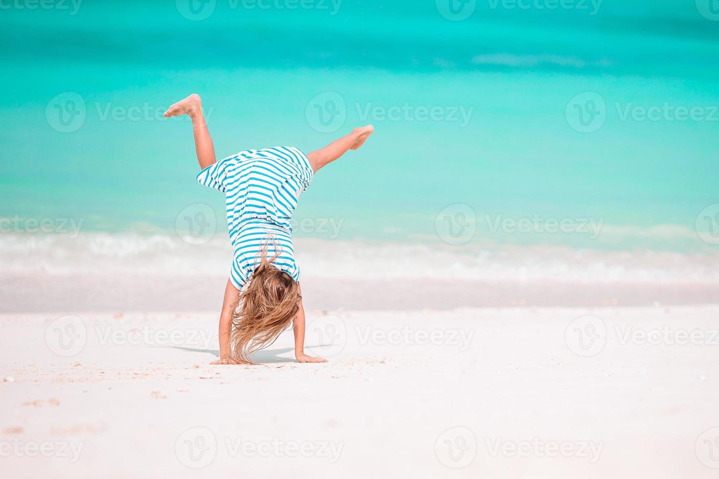 Adorable little girl at beach on her summer vacation photo