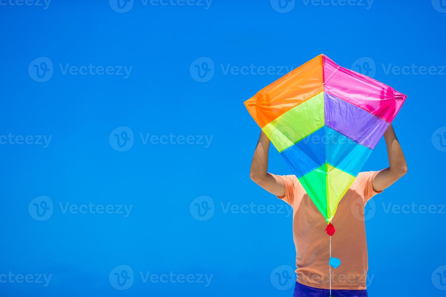 Young man with a kite on a background of turquoise sea photo