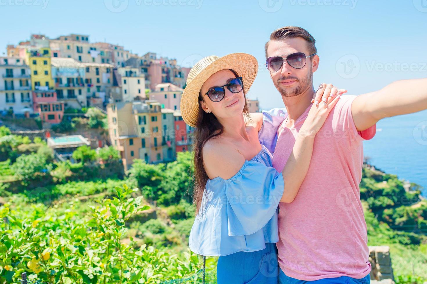 Young couple with view of the old coastal village background of Corniglia, Cinque Terre national park, Liguria, Italy ,Europe photo