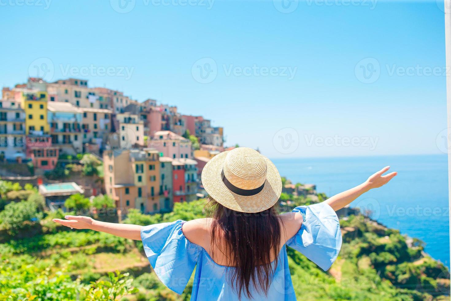 Young woman with beautiful view at old village in Cinque Terre, Liguria, Italy. European italian vacation. photo