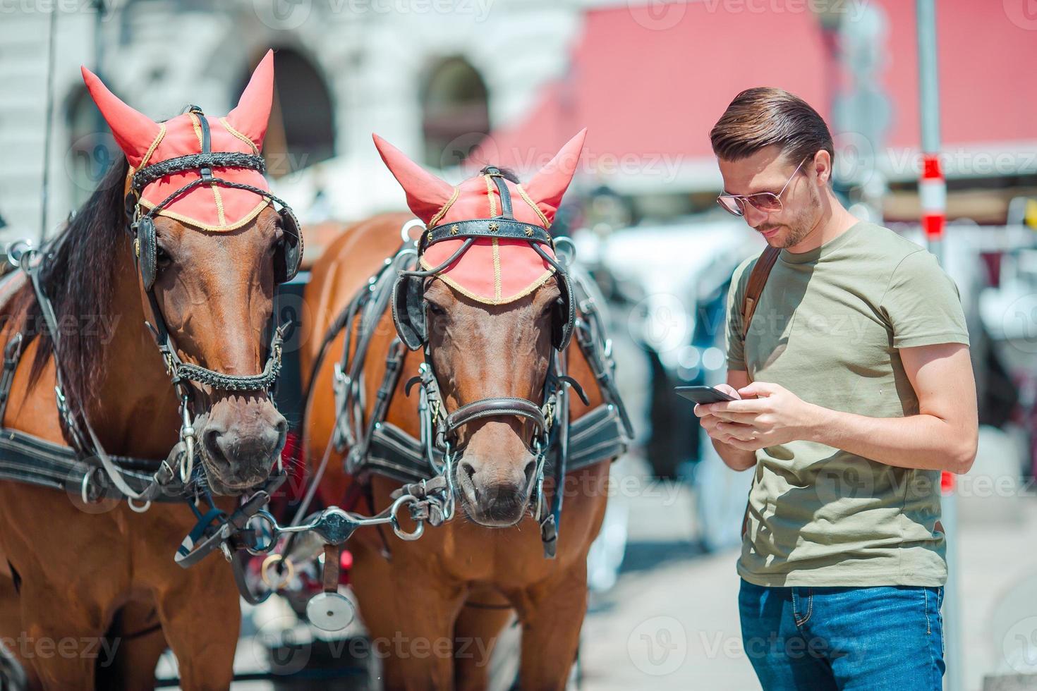 Man tourist with a city map and backpack in Europe street. Caucasian boy looking with map of European city. photo
