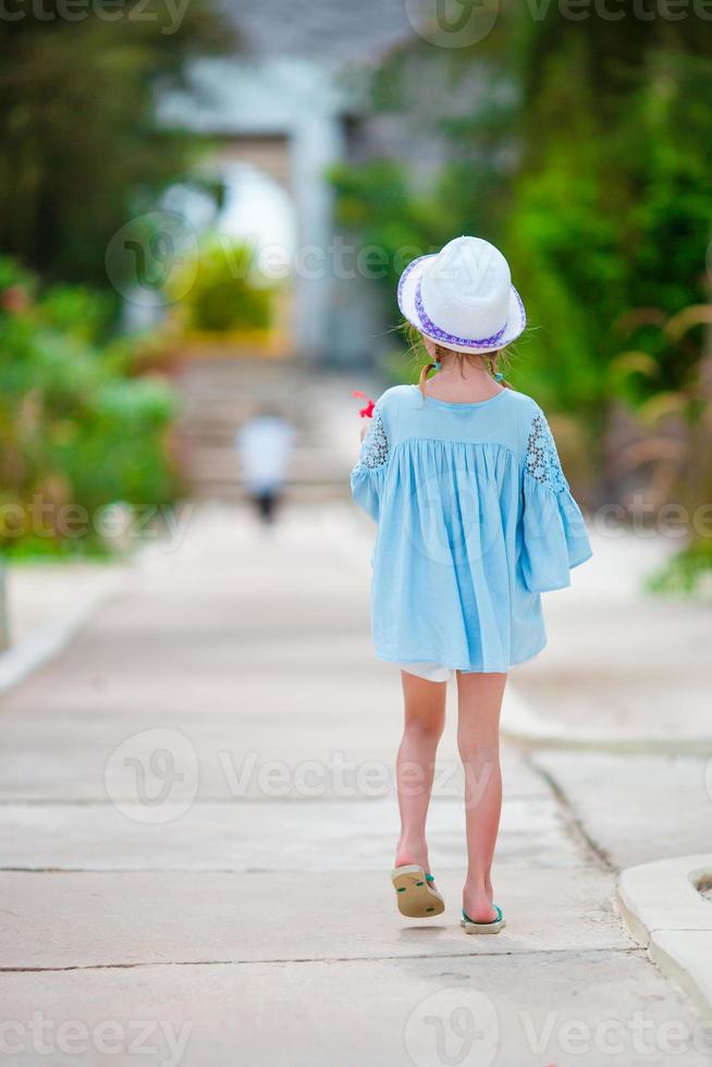 Adorable little girl on tropical beach vacation photo