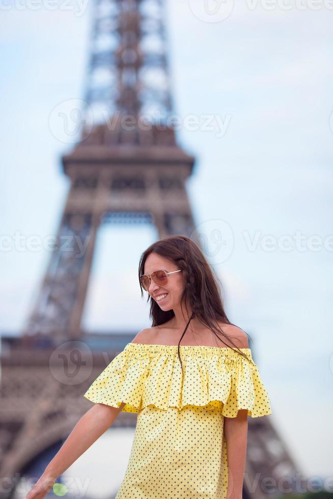 Young woman background Eiffel Tower in Paris photo