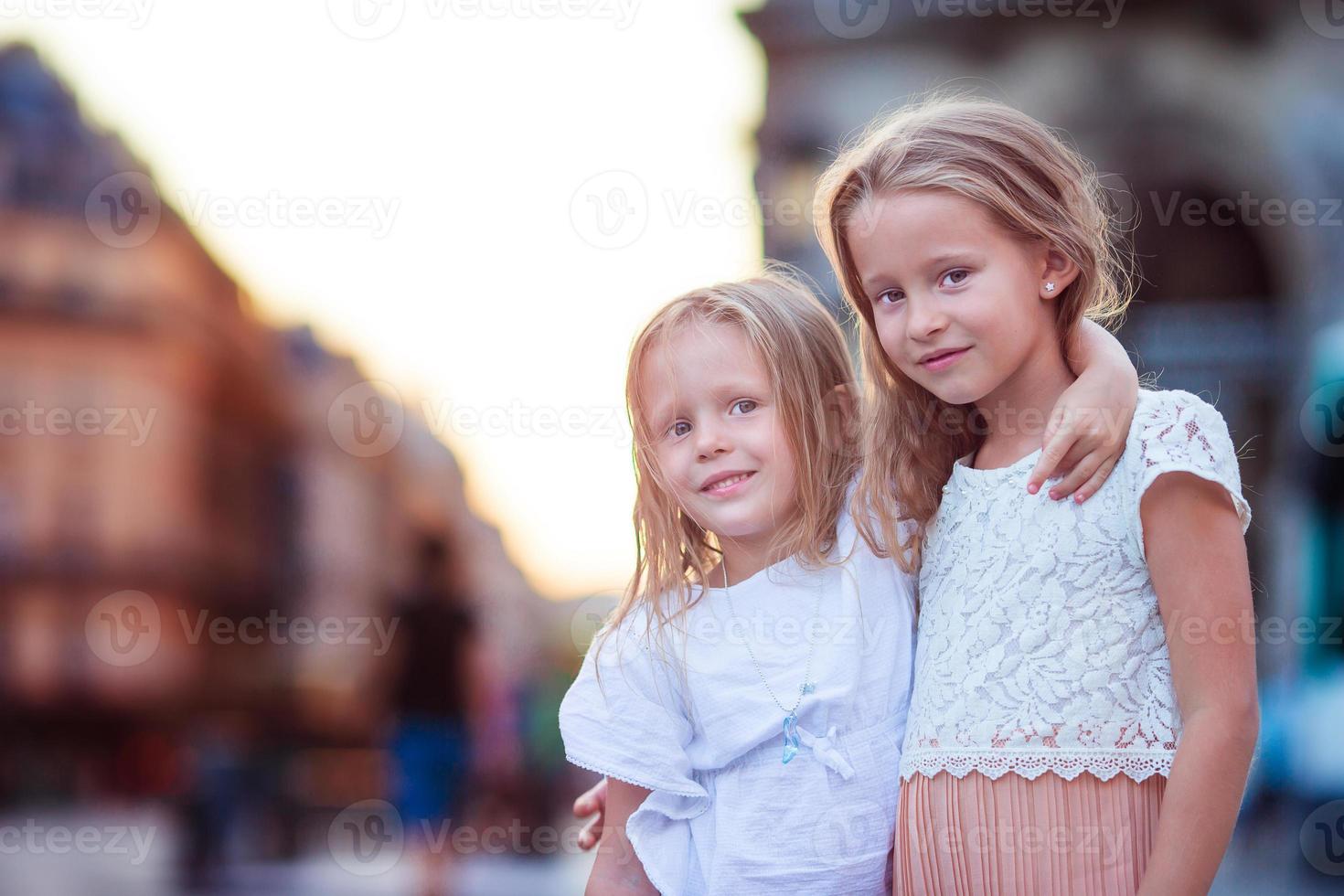 Adorable fashion little girls outdoors in European city photo
