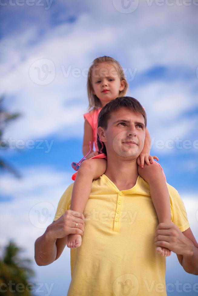 Young father with his daughter watching the sea on exotic beaches of Boracay photo