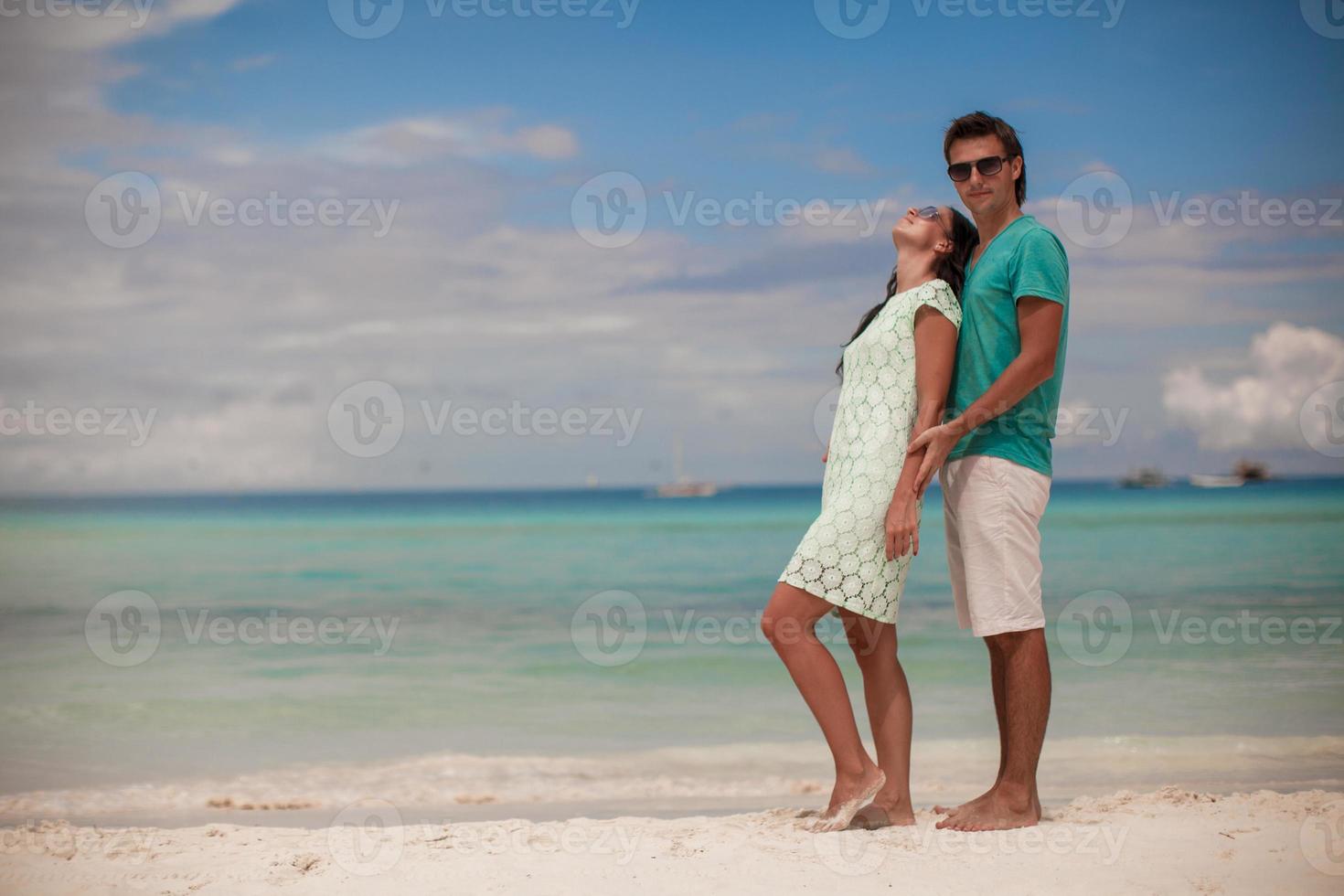 joven pareja disfrutando mutuamente en la playa de arena foto