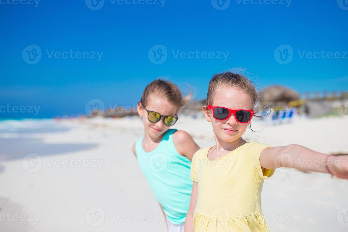 Adorable little girls during summer vacation. Kids enjoy their travel photo