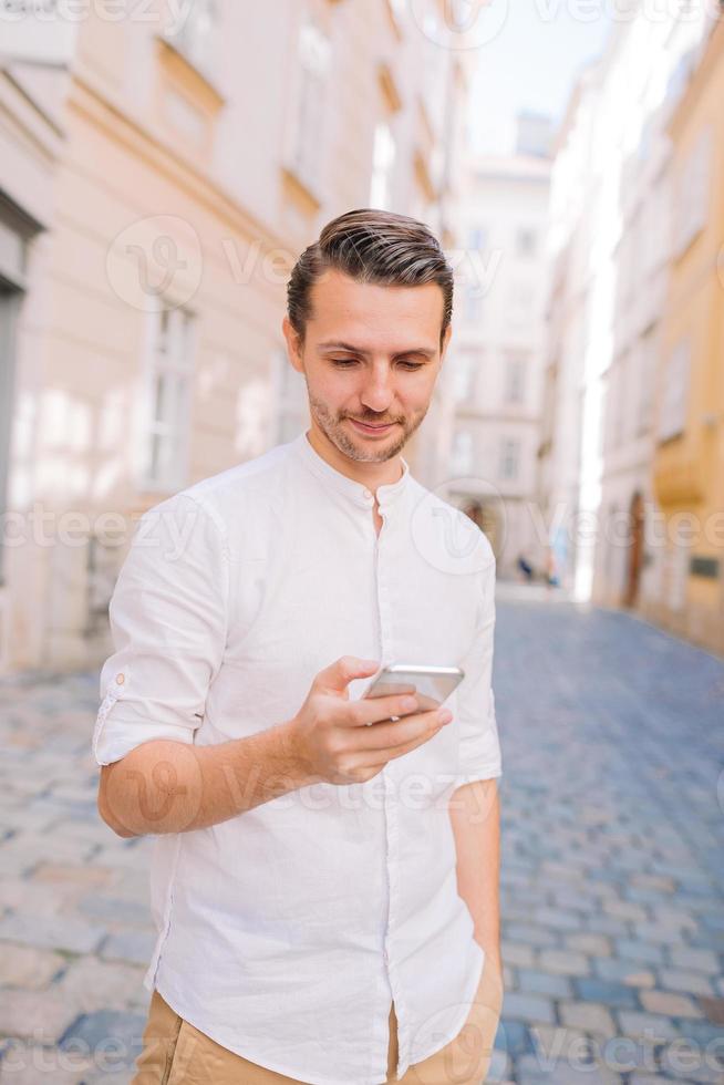 Young man background the old european city take selfie photo